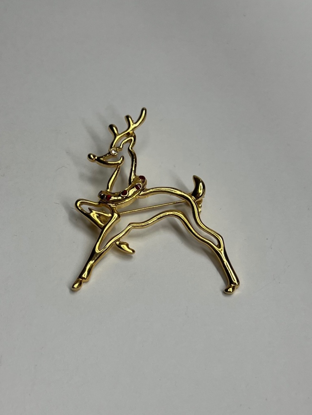 Gold deer brooch with red gemstone accents #deer #brooch